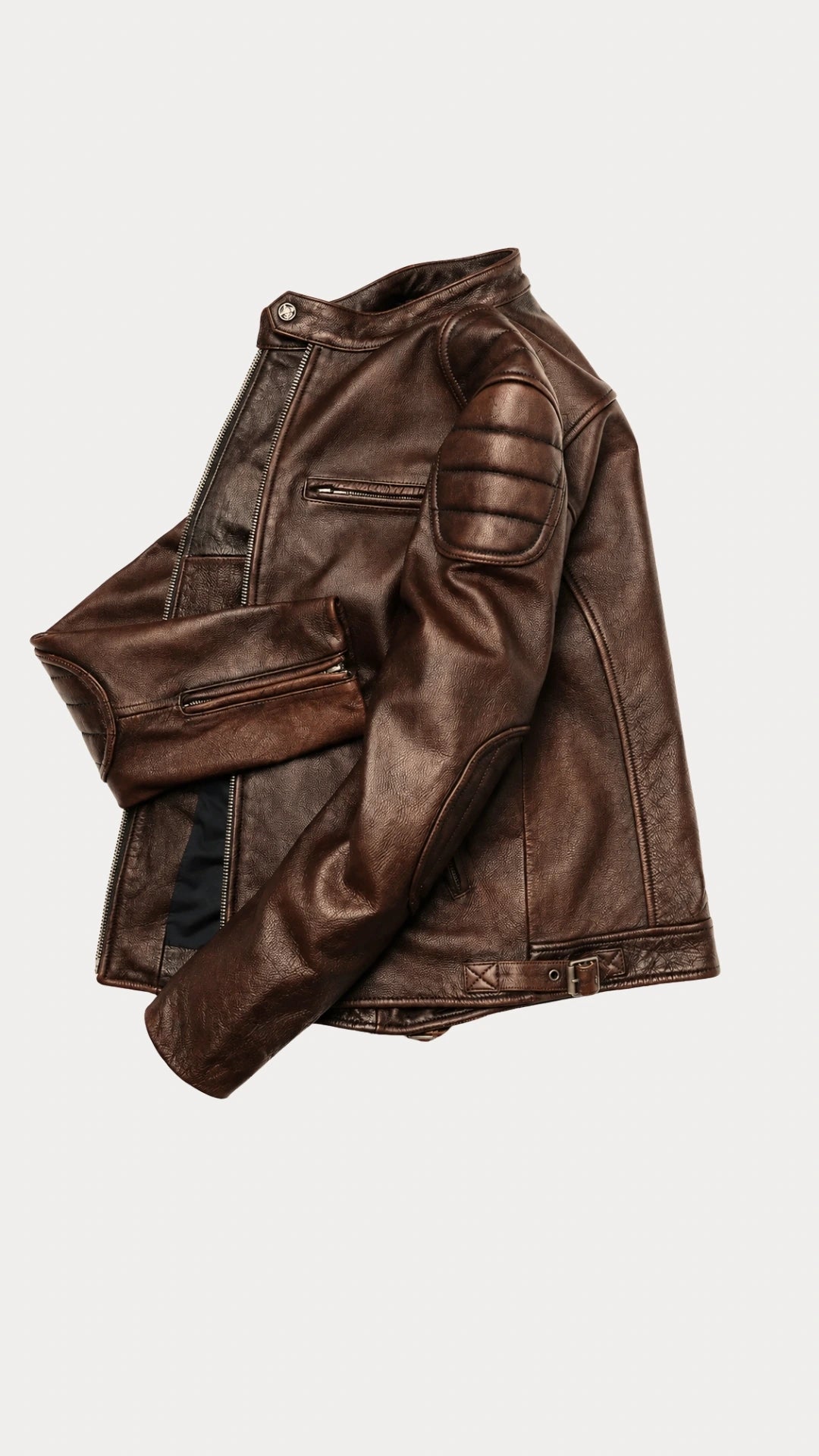 Distressed brown biker jacket folded to show the sleeve and quilted shoulder panel
