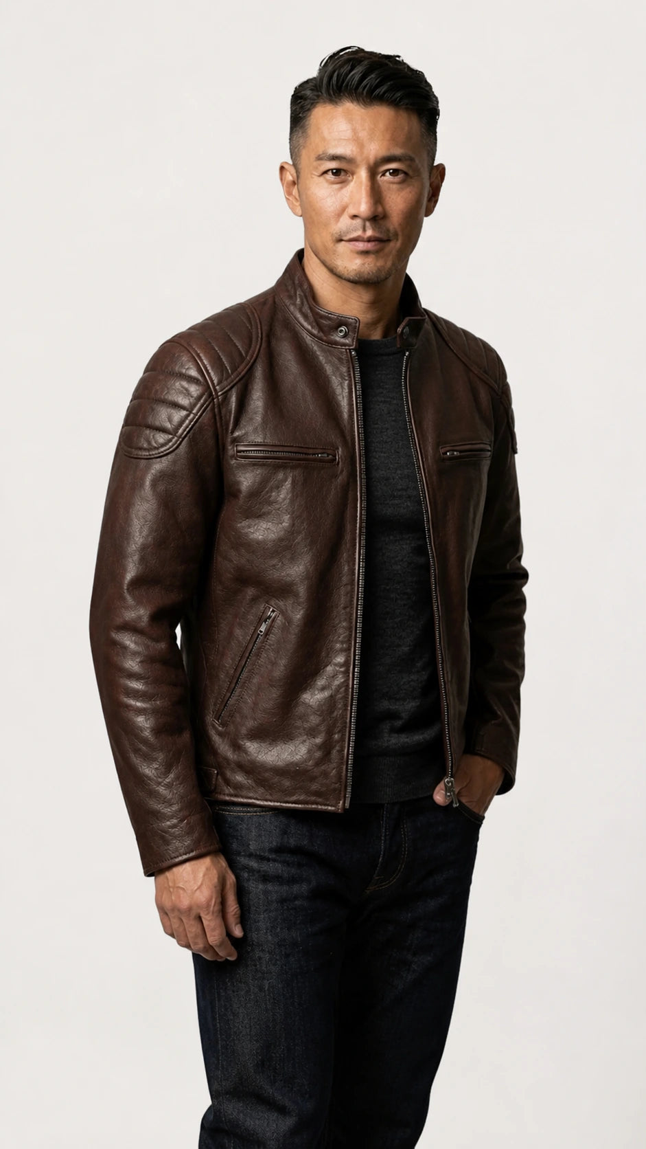 Three-quarter view of the vintage brown biker jacket worn over a grey knit