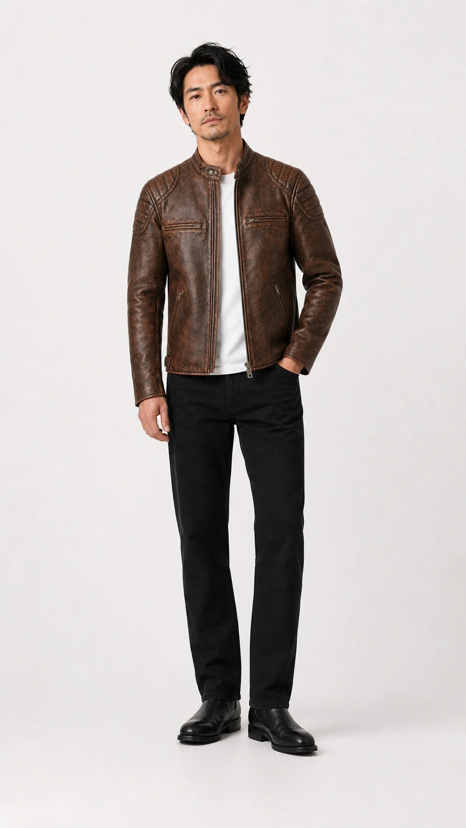 Full-length shot of a man in the distressed brown biker jacket and black trousers