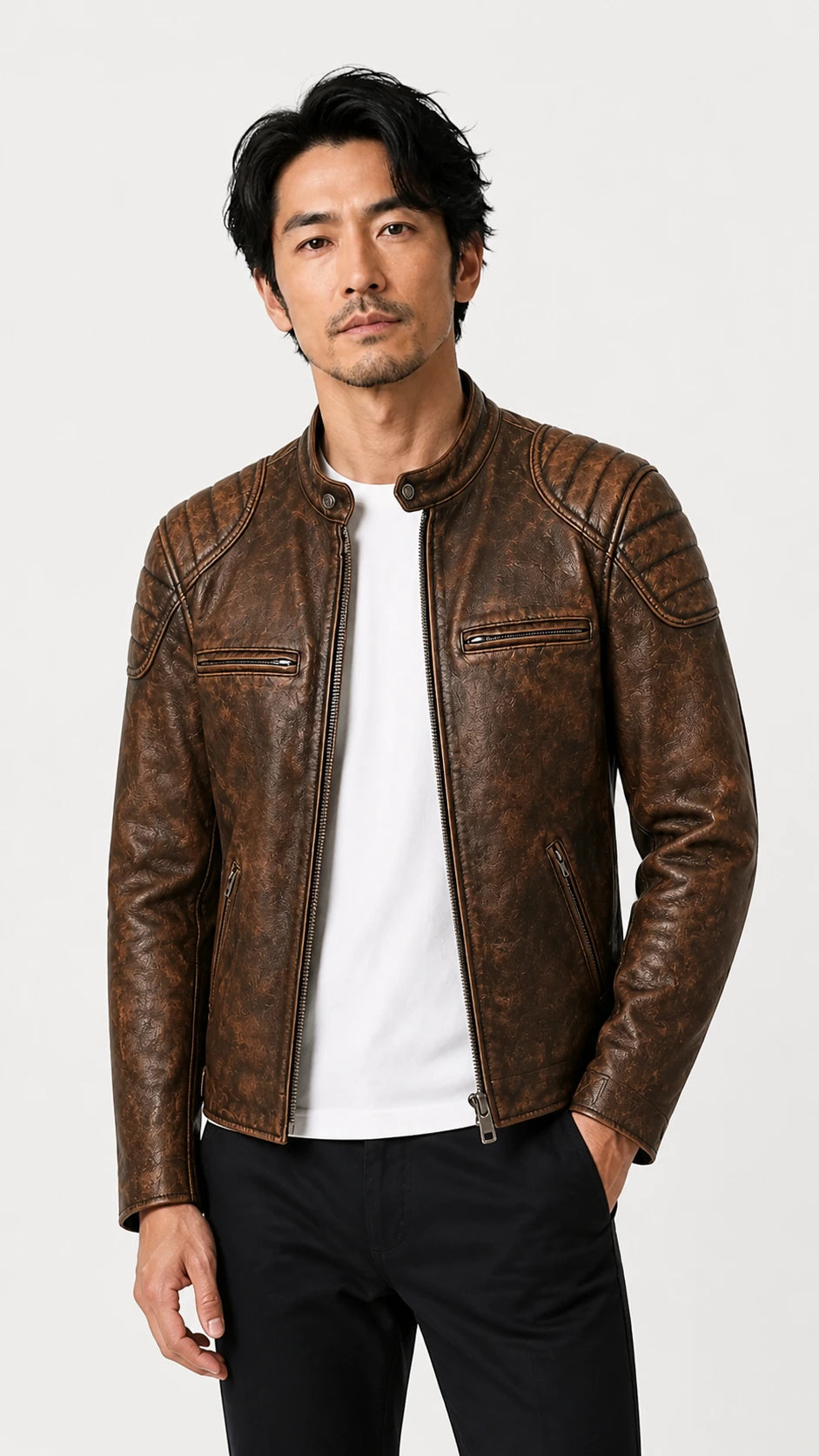 Front view of the distressed brown biker jacket worn with hands in pockets