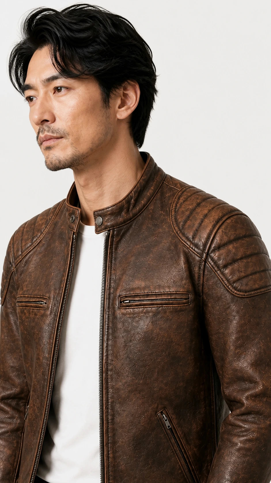Three-quarter view of the distressed brown biker jacket on the model
