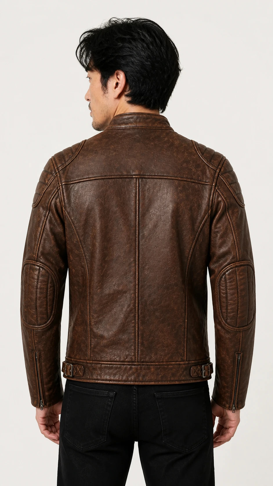 Back view of the distressed brown biker jacket worn with black trousers