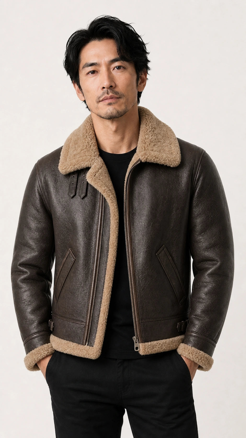 Man standing with hands in pockets in the brown B-3 shearling jacket