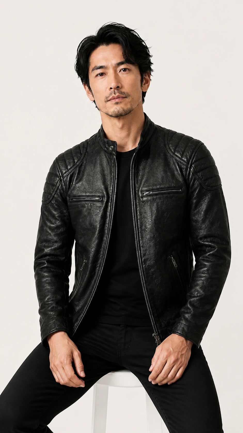 Man seated in the black leather biker jacket