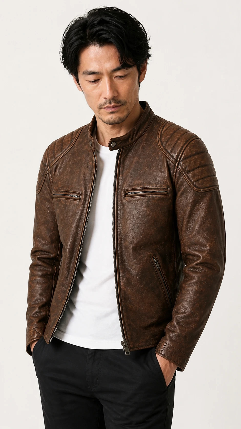 Man wearing the distressed brown biker jacket open over a white tee