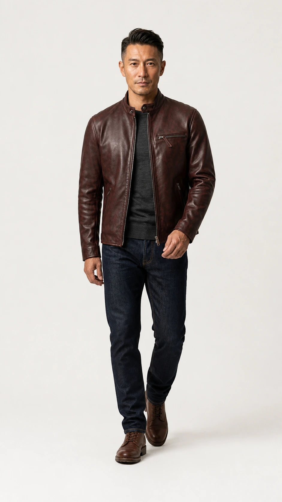 Full-length shot of a man walking in the oxblood cafe racer jacket