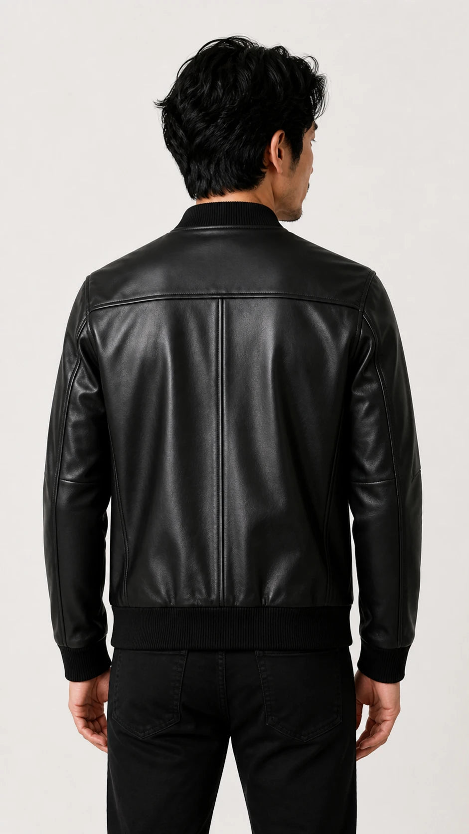 Back view of a man wearing the black leather bomber jacket