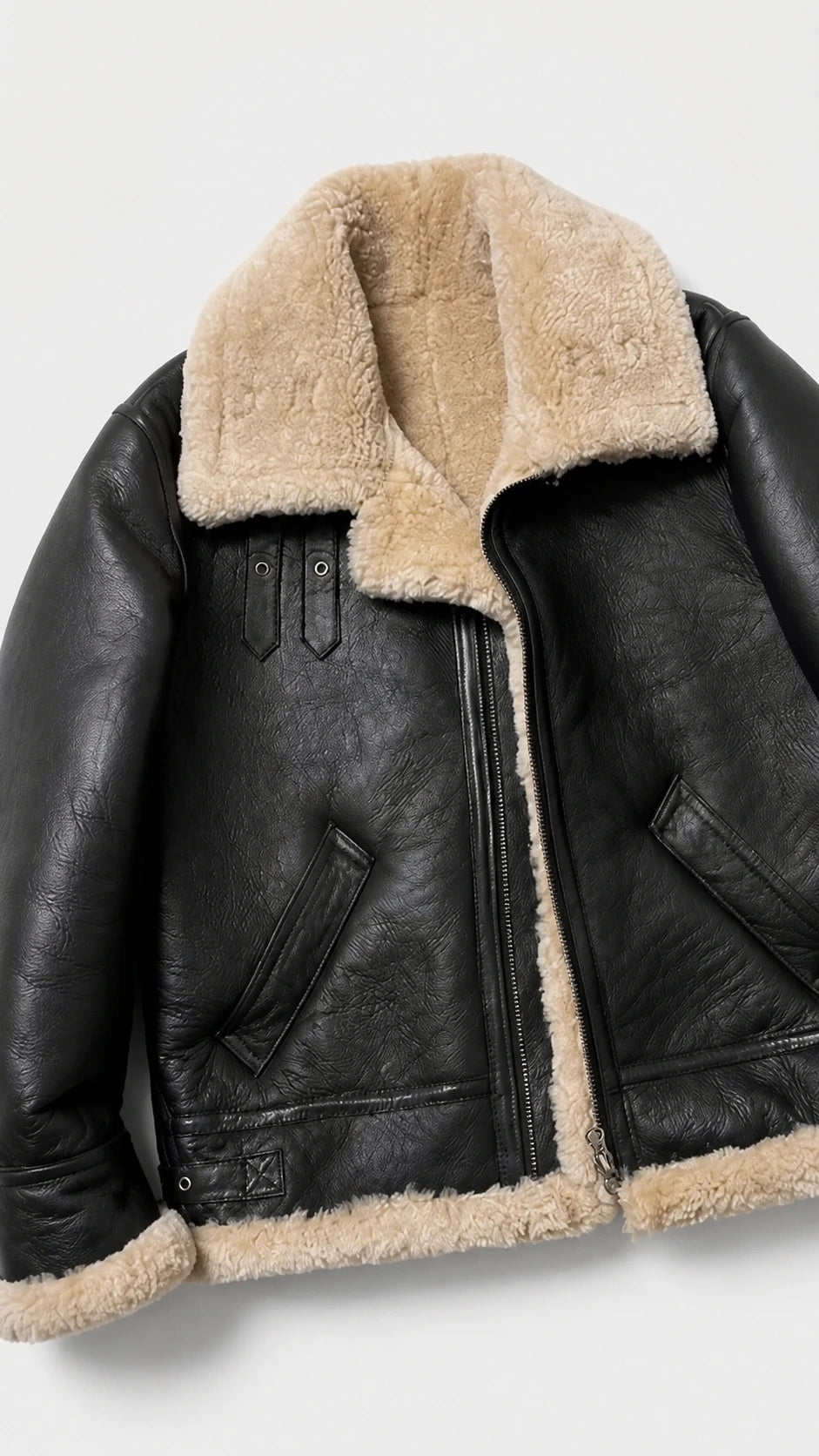 Close-up of the cream shearling collar and welt pocket on the black B-3